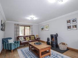 A living room with a sofa and fireplace at Burnside House in Aviemore