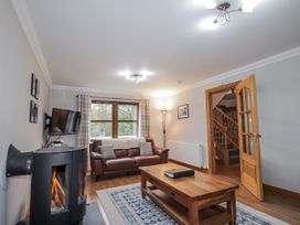 A living room with a sofa and coffee table at Burnside House, Aviemore