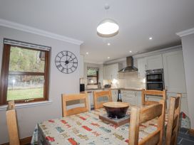 A kitchen with a table and chairs at Burnside House in Aviemore