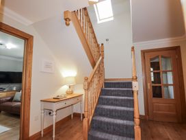 An entryway with a staircase and console table at Burnside House in Aviemore