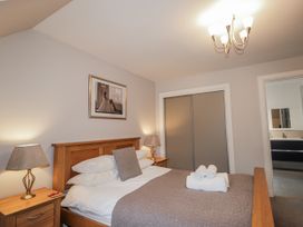 A bedroom with a bed and bedside table at Burnside House in Aviemore