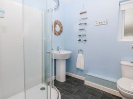 A bathroom with a shower and sink at Bwthyn y Mor in Borth-y-Gest near Porthmadog