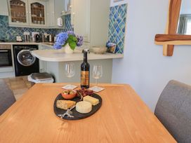 A table with wine, cheese, and grapes at Lakeside Cottage Ecclerigg near Ambleside