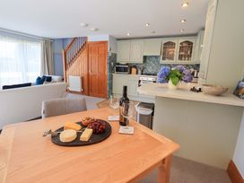 A kitchen with a dining area featuring a cheese platter at Lakeside Cottage in Ecclerigg near Ambleside