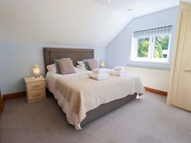 A bedroom with a bed and nightstand at Lakeside Cottage in Ecclerigg near Ambleside