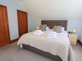 A bedroom with a bed and towels on the bed at Lakeside Cottage in Ecclerigg near Ambleside