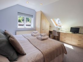 A bedroom with a bed and desk at Lakeside Cottage in Ecclerigg near Ambleside