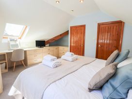 A bedroom with a bed and desk at Lakeside Cottage in Ecclerigg near Ambleside