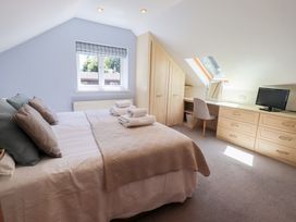 A bedroom with a bed and desk at Lakeside Cottage in Ecclerigg near Ambleside