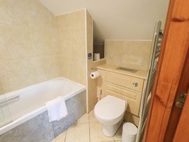 A bathroom with a bath tub and a toilet at Lakeside Cottage in Ecclerigg near Ambleside