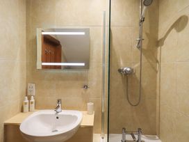 A bathroom with a sink and shower at Lakeside Cottage in Ecclerigg near Ambleside