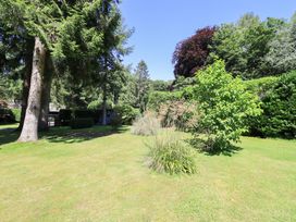 A garden with trees and shrubs at Lakeside Cottage Ecclerigg near Ambleside
