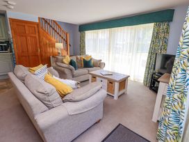 A living room with sofas and a coffee table at Waterhead Cottage in Ecclerigg, near Troutbeck Bridge
