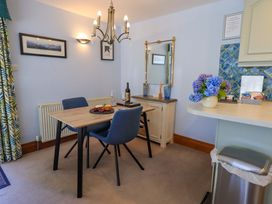 A dining room with a table and chairs at Waterhead Cottage, Ecclerigg, near Troutbeck Bridge