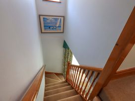A staircase with a painting and curtain at Waterhead Cottage, Ecclerigg, near Troutbeck Bridge