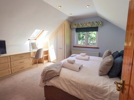 A bedroom with a bed and dresser at Waterhead Cottage, Ecclerigg, near Troutbeck Bridge