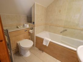 A bathroom with toilet, bathtub, and sink at Waterhead Cottage, Ecclerigg, near Troutbeck Bridge