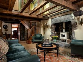 A living room with a sofa, armchair, and coffee table at The Meeting House in Ashburton