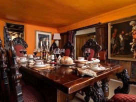 A dining room with a large table set for a meal at The Meeting House in Ashburton