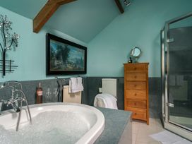 A bathroom with a bathtub and shower at The Meeting House in Ashburton