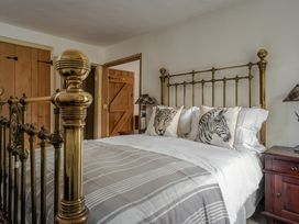 A bedroom with a bed and wardrobe at The Meeting House in Ashburton