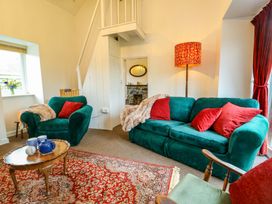 A living room with a green sofa and coffee table at Ael Y Bryn in Menai Bridge