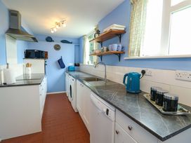 A kitchen with a sink and appliances at Ael Y Bryn in Menai Bridge