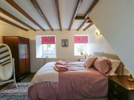 A bedroom with a bed and wardrobe at Ael Y Bryn Menai Bridge
