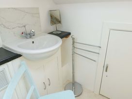 A bathroom with a sink and mirror at Ael Y Bryn Menai Bridge