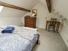 A bedroom with a bed, dresser, and chair at Ael Y Bryn in Menai Bridge