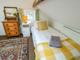 A bedroom with a bed and a dresser at Ael Y Bryn in Menai Bridge
