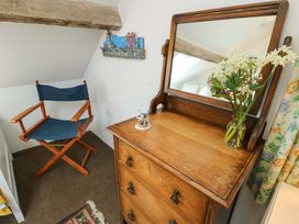 A bedroom with a chair and dressing table at Ael Y Bryn in Menai Bridge