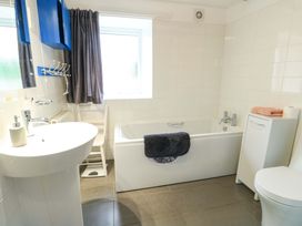 A bathroom with a bathtub, sink, and toilet at Ael Y Bryn in Menai Bridge