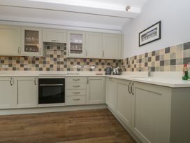 A kitchen with cabinets and appliances at High Spy in Keswick