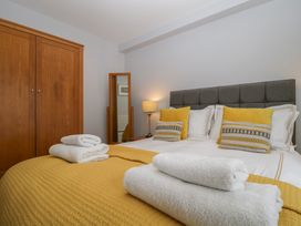 A bedroom with a bed and wardrobe at High Spy in Keswick