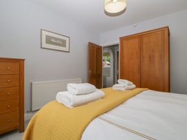 A bedroom with a bed and wood furniture at High Spy in Keswick