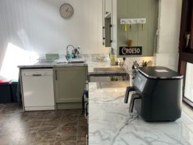 A kitchen with a sink and dishwasher at Bryn Eira Stables Llanfair PG