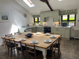 A kitchen with a table and chairs at Bryn Eira Stables in Llanfair PG