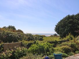 A view of ocean and greenery from the garden at Bryn Y Mor, Borth Y Gest