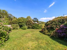 A garden with bushes and grass at Bryn Y Mor, Borth Y Gest