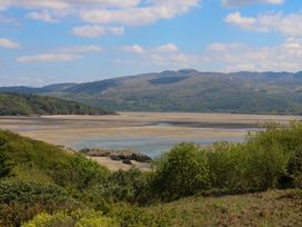 A view of a river, mountains and vegetation at Bryn Y Mor,  Borth Y Gest