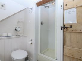 A bathroom with a shower and toilet at Y Bwthyn in Criccieth