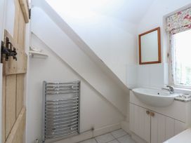 A bathroom with a sink and towel radiator at Y Bwthyn in Criccieth