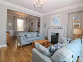 A living room with sofas and a coffee table at Captain's Rest in Criccieth
