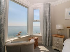 A bedroom with a view of the sea at Captain's Rest in Criccieth