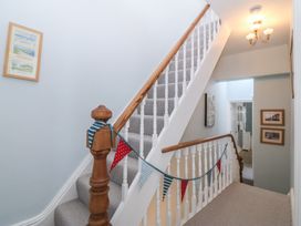 A staircase with a bunting decoration at Captain's Rest in Criccieth
