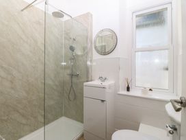 A bathroom with a shower, sink and toilet at Captain's Rest in Criccieth
