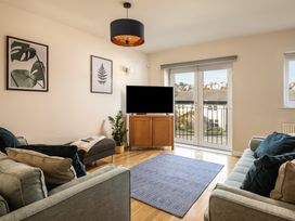 A living room with a television and sofa at Coed y Felin in Conwy