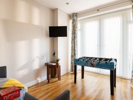 A games room with a foosball table and TV at Coed y Felin in Conwy