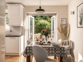 A dining room with a table set for meals at Coed y Felin in Conwy